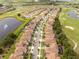 Long aerial view of the neighborhood with the golf course and pond in the background at 1097 Trappers Trail Loop, Davenport, FL 33896