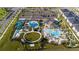 Community aerial view of resort-style pools, lazy river, water slides, grassy play areas, and landscaping at 1097 Trappers Trail Loop, Davenport, FL 33896