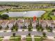 An aerial view of a neighborhood with houses, a lake and a golf course at 1097 Trappers Trail Loop, Davenport, FL 33896