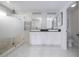 Modern bathroom with a frameless glass shower, double vanity, and contemporary fixtures, creating a spa-like experience at 1097 Trappers Trail Loop, Davenport, FL 33896