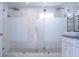 Bright bathroom with a spacious dual-head shower, modern vanity, and heated towel rack, providing convenience at 1097 Trappers Trail Loop, Davenport, FL 33896