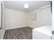 Minimalist bedroom featuring laminate flooring, a window with white drapes, and modern art at 1097 Trappers Trail Loop, Davenport, FL 33896