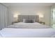 Comfortable bedroom featuring a gray headboard, decorative pillows, and contemporary bedside lamps at 1097 Trappers Trail Loop, Davenport, FL 33896