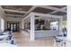 View of the clubhouse bar area with seating, ceiling fans, pendant lighting, and large screen televisions at 1097 Trappers Trail Loop, Davenport, FL 33896