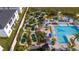 Aerial view of community amenities, including a pool, mini golf, seating, and tropical landscaping at 1097 Trappers Trail Loop, Davenport, FL 33896