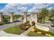 View of the ChampionsGate entrance, showing manicured landscaping, signage, and access roads for a welcoming arrival at 1097 Trappers Trail Loop, Davenport, FL 33896