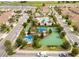 Aerial view of a community park that includes a playground, bocce ball court, and lovely landscaping at 1097 Trappers Trail Loop, Davenport, FL 33896