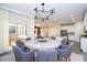 Dining room featuring a modern chandelier, round table, seating for eight, and sliding glass doors at 1097 Trappers Trail Loop, Davenport, FL 33896