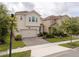 Beautiful two-story home with a paved driveway and lush landscaping at 1097 Trappers Trail Loop, Davenport, FL 33896