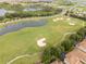 This is an aerial view of the golf course with sand traps, green grass and water at 1097 Trappers Trail Loop, Davenport, FL 33896