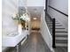 Elegant hallway with hardwood floors, modern decor, and a staircase at 1097 Trappers Trail Loop, Davenport, FL 33896
