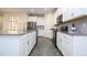 Bright kitchen with white cabinets, stainless steel appliances, and grey countertops, perfect for cooking at 1097 Trappers Trail Loop, Davenport, FL 33896
