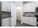 Walk-in pantry with wire shelving, providing ample storage space adjacent to the kitchen at 1097 Trappers Trail Loop, Davenport, FL 33896