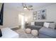 Cozy living room with neutral tones, a comfortable sectional sofa, and decorative wall art at 1097 Trappers Trail Loop, Davenport, FL 33896