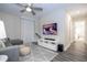 Relaxing living room featuring a grey sectional, mounted TV, accent wall, and an open floor plan at 1097 Trappers Trail Loop, Davenport, FL 33896