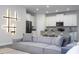 Contemporary living room with an open floor plan, modern lighting, and kitchen view at 1097 Trappers Trail Loop, Davenport, FL 33896