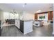 Open-concept living space with modern kitchen, dining area, and comfortable seating arrangement at 1097 Trappers Trail Loop, Davenport, FL 33896