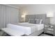 Bright and airy main bedroom boasts a luxurious bed, mirrored nightstands and plush bedding at 1097 Trappers Trail Loop, Davenport, FL 33896