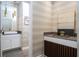Modern powder room with elegant lighting, stylish mirror, and decorative accents at 1097 Trappers Trail Loop, Davenport, FL 33896