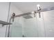 Modern walk-in shower featuring a rainfall shower head with glass door at 1097 Trappers Trail Loop, Davenport, FL 33896
