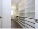 Spacious walk-in closet with custom shelving and drawers, maximizing storage space and organization at 1097 Trappers Trail Loop, Davenport, FL 33896