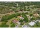 Aerial view showcasing property's location near a golf course, surrounding landscape, and neighborhood at 1111 Pinar Dr, Orlando, FL 32825