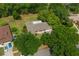 Aerial view of property, showcasing proximity to a golf course and mature tree coverage at 1111 Pinar Dr, Orlando, FL 32825