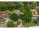Aerial view of home nestled among trees with lush landscaping, showcasing its setting at 1111 Pinar Dr, Orlando, FL 32825