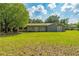 Expansive backyard featuring a lush lawn and patio with plenty of space for outdoor activities at 1111 Pinar Dr, Orlando, FL 32825