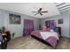 This bedroom includes a ceiling fan and two windows with curtains at 1111 Pinar Dr, Orlando, FL 32825