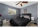 This bedroom features a ceiling fan and a window letting in natural light at 1111 Pinar Dr, Orlando, FL 32825