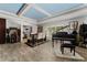 Open dining room with a sleek table, piano, and light blue ceiling, perfect for gatherings at 1111 Pinar Dr, Orlando, FL 32825