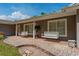 Inviting front porch with two hanging porch swings and brick-paved patio. A nice place to relax at 1111 Pinar Dr, Orlando, FL 32825