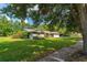 Charming home featuring a well-manicured front yard and mature trees at 1111 Pinar Dr, Orlando, FL 32825