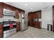 Functional kitchen with stainless steel appliances, granite countertops, and wood flooring at 1111 Pinar Dr, Orlando, FL 32825