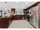 Modern kitchen with stainless steel appliances, dark wood cabinets, and ample counter space at 1111 Pinar Dr, Orlando, FL 32825