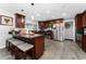 Well-equipped kitchen with stainless steel appliances, dark cabinets, and breakfast bar seating at 1111 Pinar Dr, Orlando, FL 32825