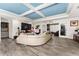 Stylish living room featuring a modern sofa, tiled floors, accent wall, and a unique blue ceiling at 1111 Pinar Dr, Orlando, FL 32825