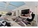 Spacious living room features modern décor, a large screen TV, and unique ceiling design at 1111 Pinar Dr, Orlando, FL 32825