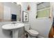Half-bathroom featuring modern sink, toilet, and decorative accents at 1111 Pinar Dr, Orlando, FL 32825
