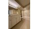 Bathroom featuring double vanity, shower and tub with white tile surround at 12016 Villanova Dr # 102, Orlando, FL 32837