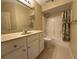 Bathroom featuring a single sink vanity, large mirror, and shower-tub combo at 12016 Villanova Dr # 102, Orlando, FL 32837