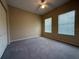 Bedroom featuring two windows for natural light, neutral walls, ceiling fan, and closet at 12016 Villanova Dr # 102, Orlando, FL 32837