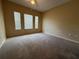 Spacious bedroom featuring neutral colored walls, carpet and three windows with blinds at 12016 Villanova Dr # 102, Orlando, FL 32837