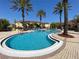 This resort-style pool has a beach entry and a luxurious sunbathing patio at 12016 Villanova Dr # 102, Orlando, FL 32837