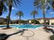 Enjoy the community pool surrounded by beautiful palm trees and lush landscaping at 12016 Villanova Dr # 102, Orlando, FL 32837