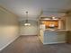 Dining area next to the kitchen, showcasing the open floor plan and a modern chandelier at 12016 Villanova Dr # 102, Orlando, FL 32837