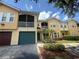 Inviting two-story condo with a screened balcony and a well-maintained landscaped front yard at 12016 Villanova Dr # 102, Orlando, FL 32837