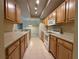 Kitchen featuring wooden cabinets and white appliances, offers plenty of counter space at 12016 Villanova Dr # 102, Orlando, FL 32837