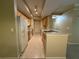 Bright galley kitchen with tile floors, wooden cabinets, and white appliances at 12016 Villanova Dr # 102, Orlando, FL 32837